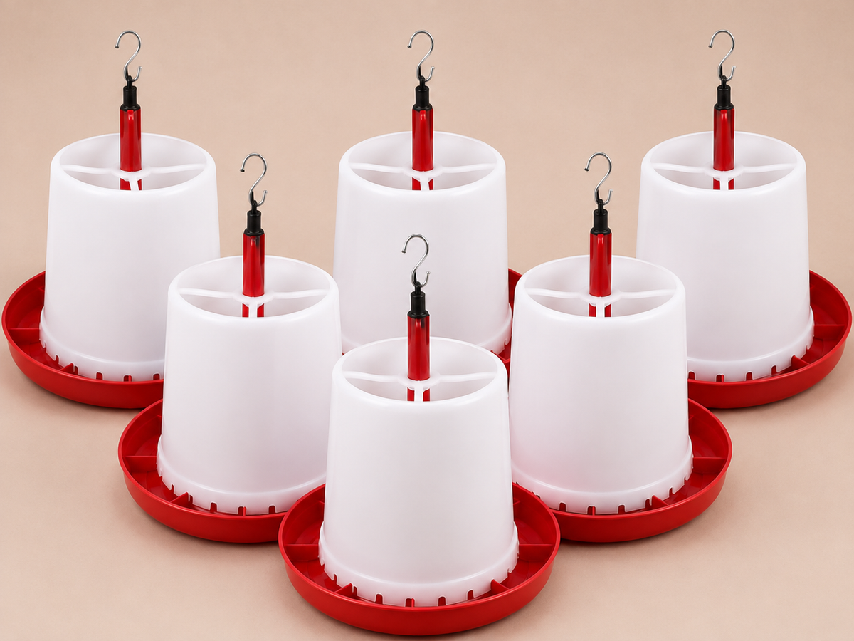 Six white plastic poultry super feeder with red bases and red hanging tubes, arranged on a beige background.